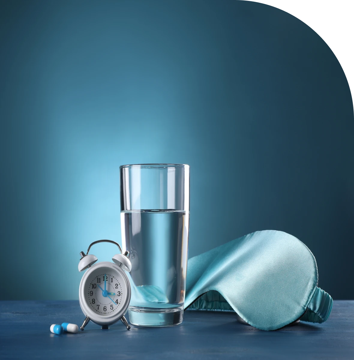 Alarm clock, water glass, and sleep mask